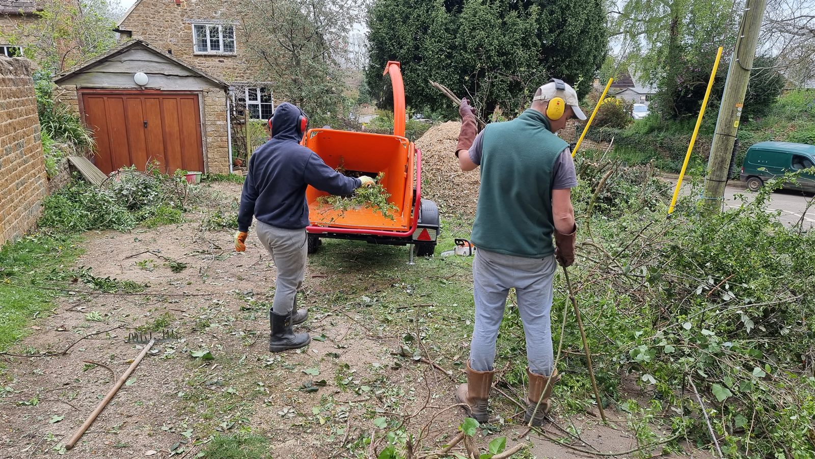 Garden cuttings being processed with a wood chipper.